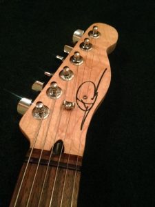 Guitar headstock with black waterslide decal.